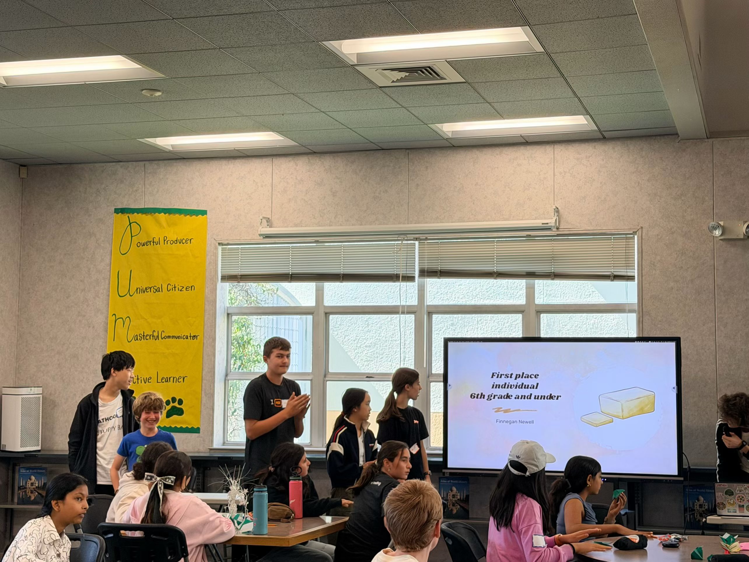 Students at the awards ceremony with a first place slide on the screen