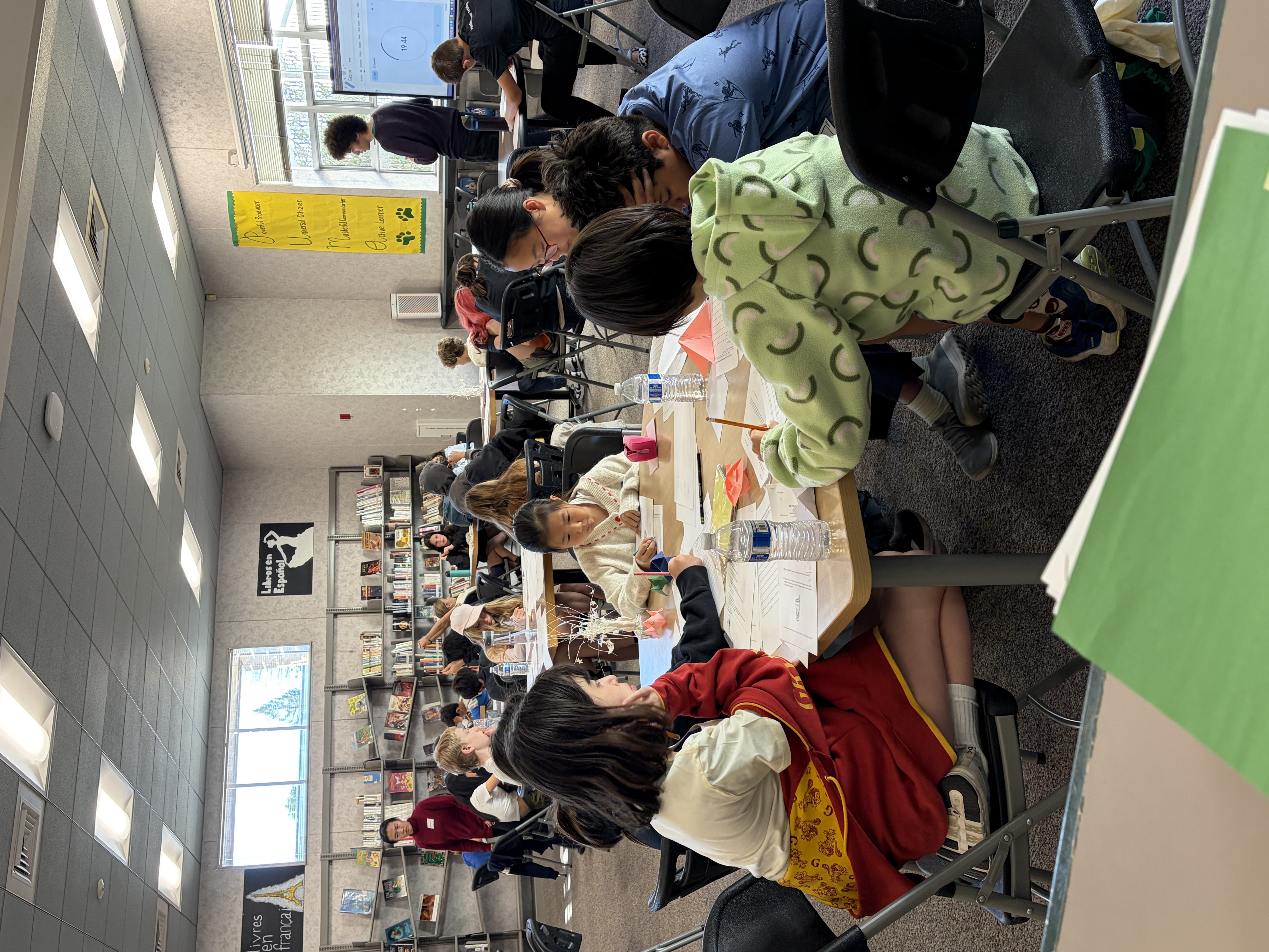 Students concentrating together at a table during the competition