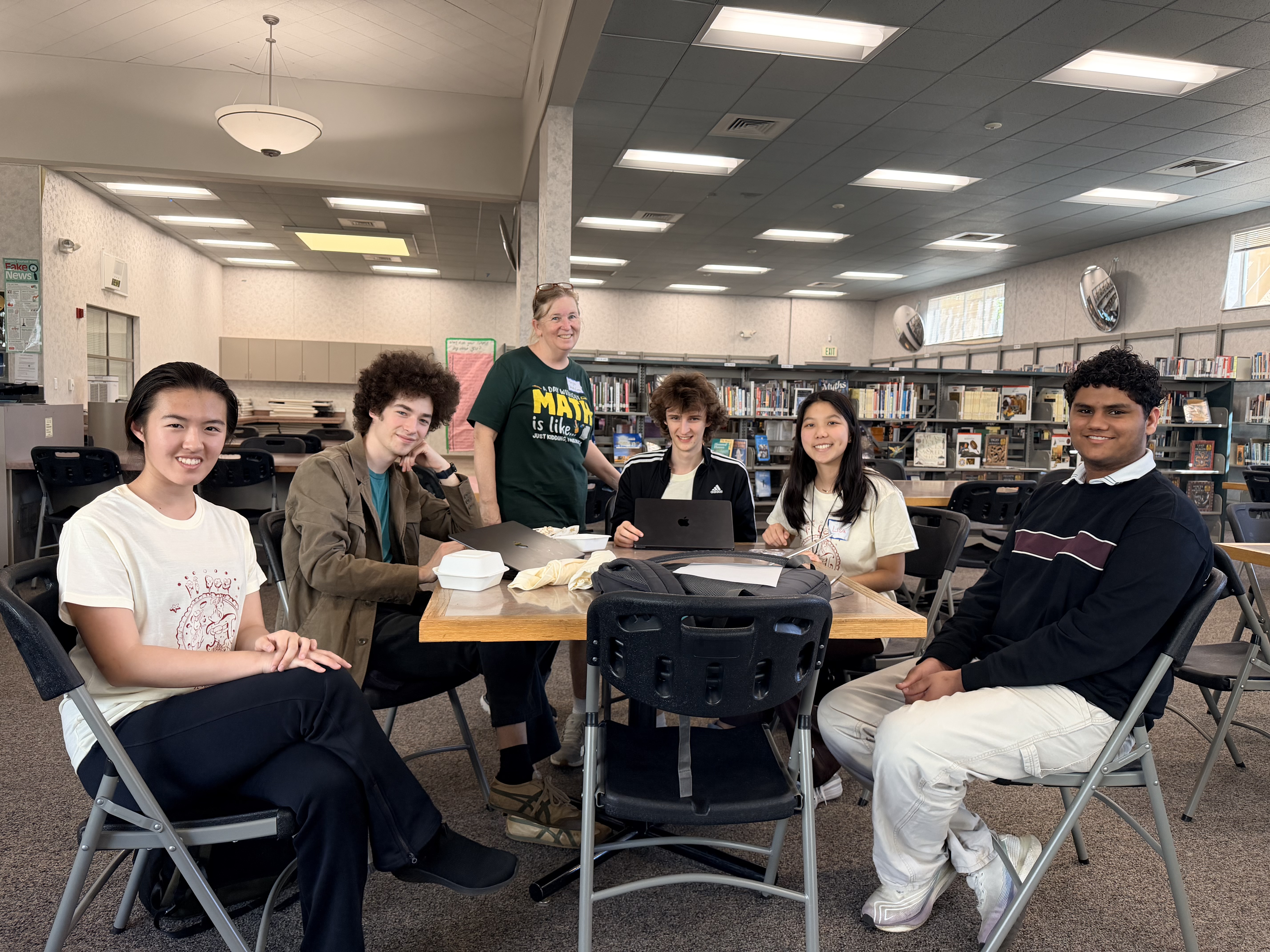 Organizers and volunteers posing together at a table